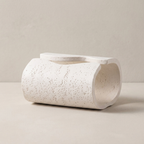 White ceramic planter on a beige background