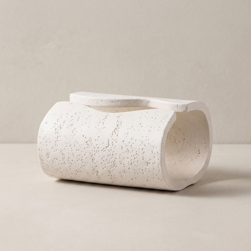 White ceramic planter on a beige background