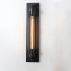 Wall-mounted light fixture with a long, illuminated bulb on a white background