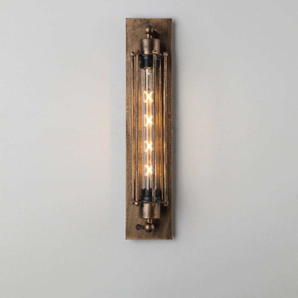 Vintage-style wall sconce with metallic finish on a plain background