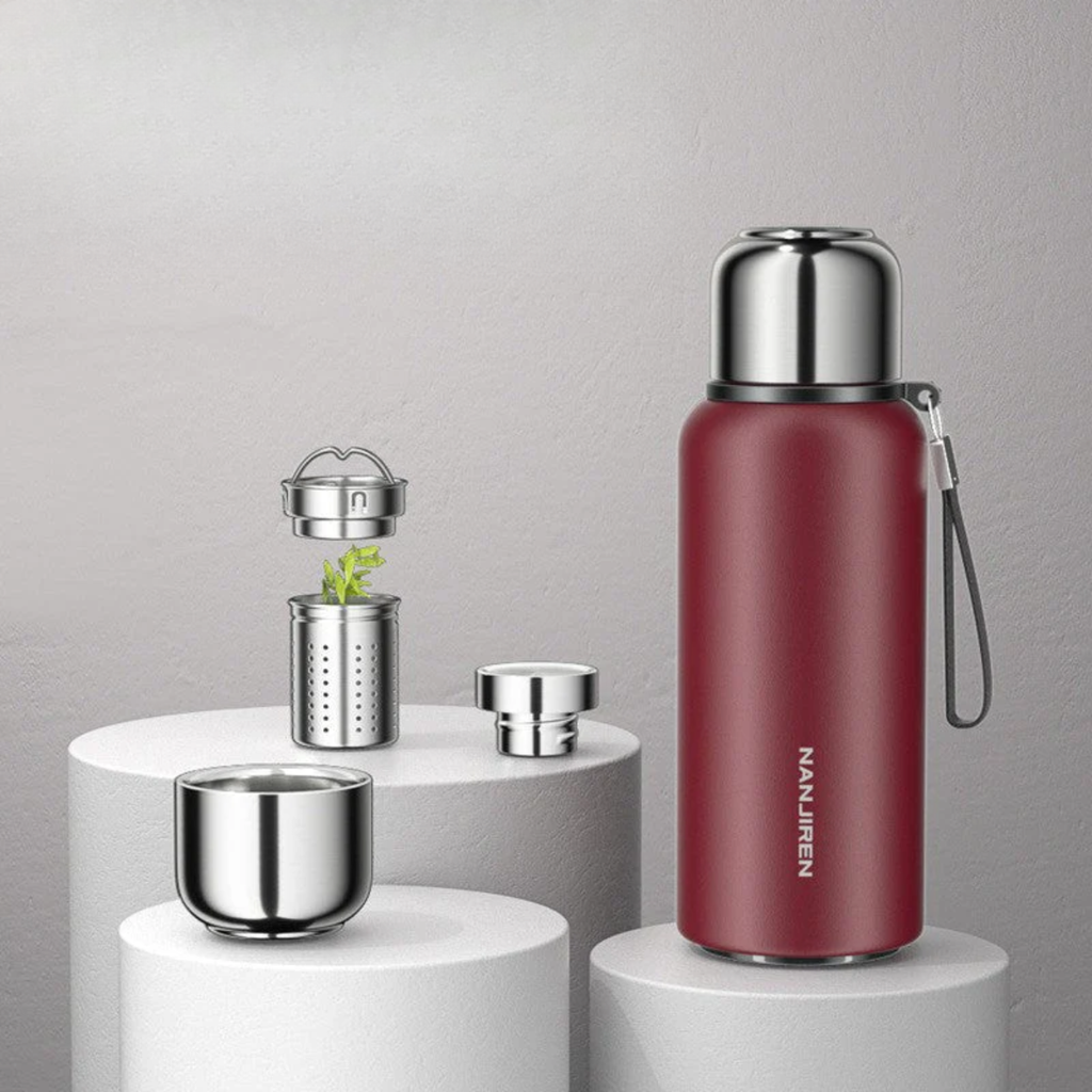 Red thermos bottle with silver accents on a gray background