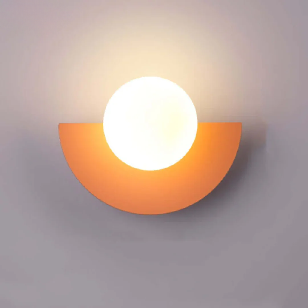 Wall-mounted light fixture with a half-circle orange shade on a gray background