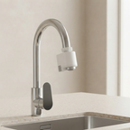 A modern high-arc chrome faucet with a white cylindrical filter attachment and a dark gray handle, installed on a light beige countertop above a stainless steel sink.