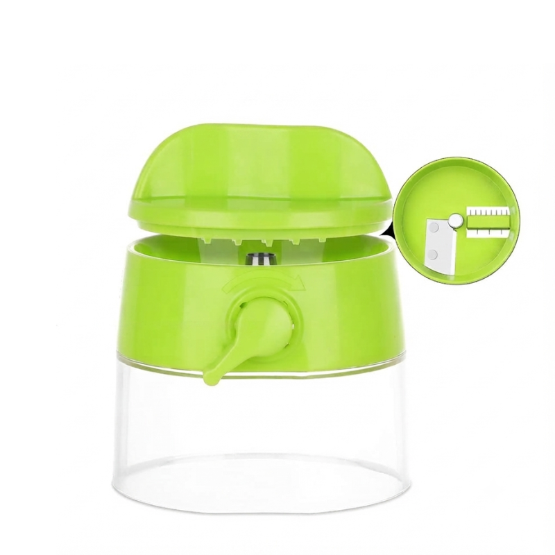 A bright lime green manual food chopper with a clear plastic container base, shown with its lid open and a circular inset detail of the blade mechanism.