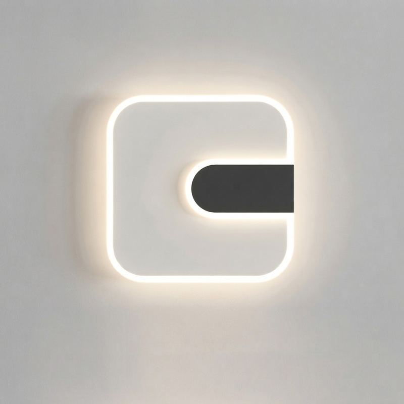 A modern square wall sconce with a glowing white LED border and a central black horizontal bar, mounted on a light gray wall.