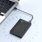 Black external hard drive connected to a laptop on a light blue background