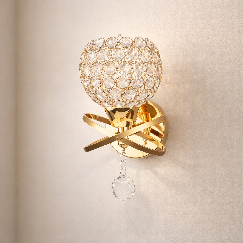 Gold wall sconce with crystal details on a beige wall
