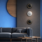 Modern living room with a gray sofa, wooden coffee table, and decorative wall lights.