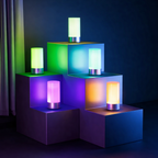 Colorful cylindrical lamps on geometric blue shelves against a dark background