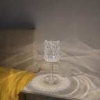 Crystal glass on a reflective surface with a soft, diffused light
