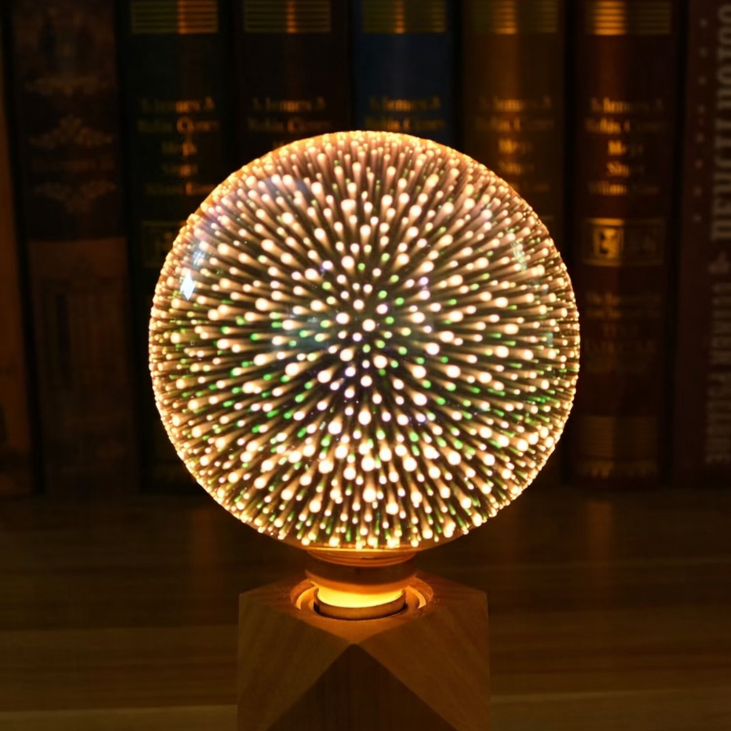 Decorative light bulb with a starburst pattern on a wooden stand, against a blurred bookshelf background.