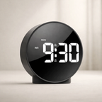 Black digital clock with white display on a light background