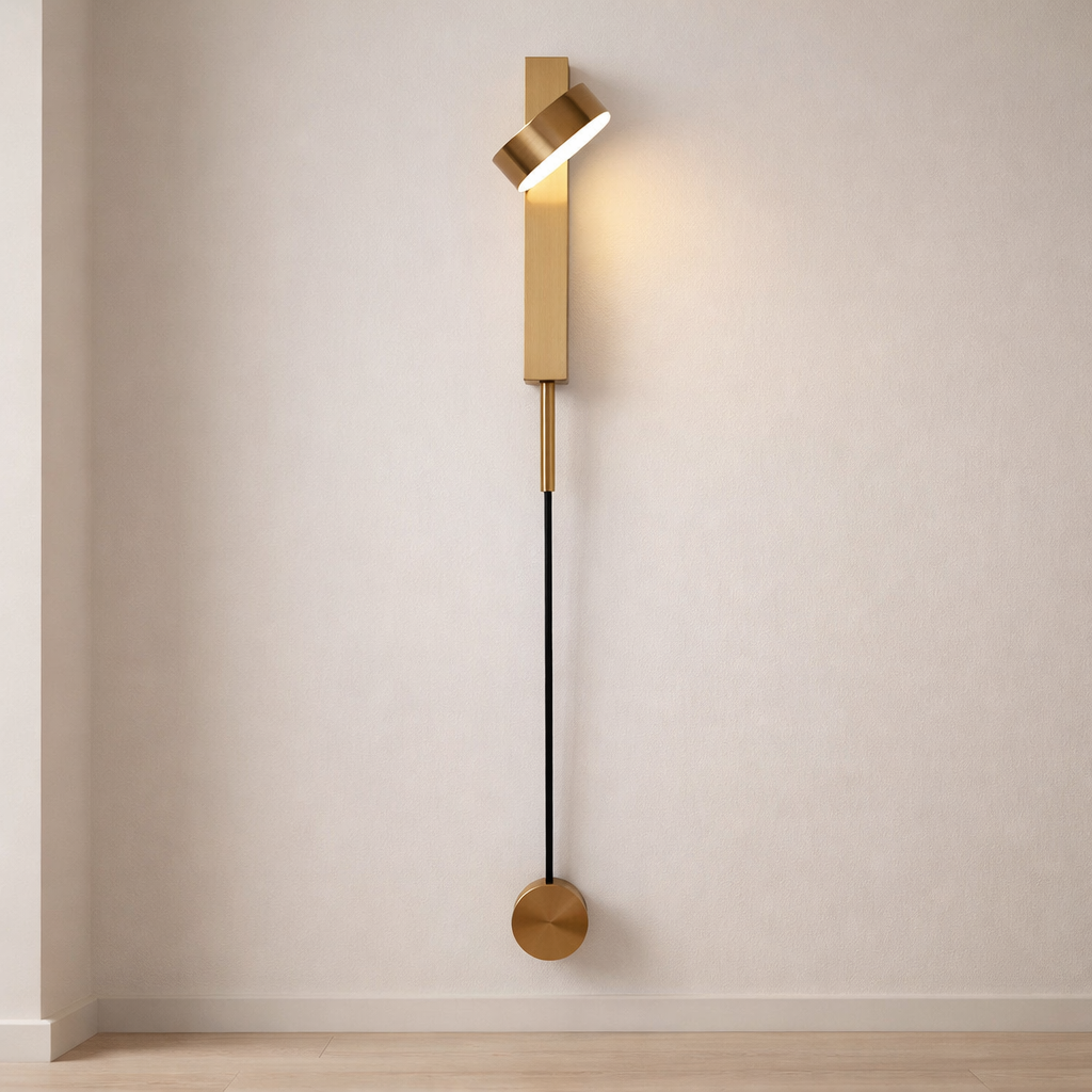 Modern wall lamp with gold fixture and black cable on a neutral wall.