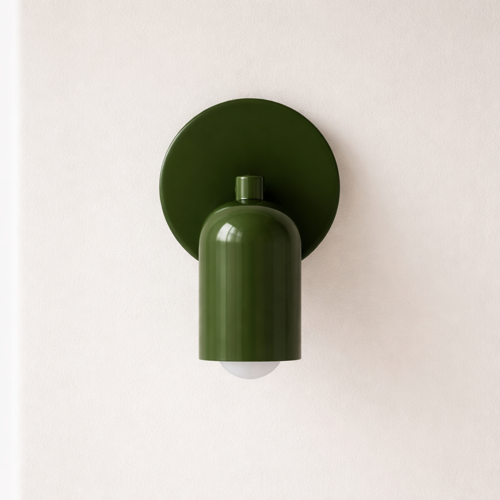 Green wall-mounted light fixture on a white wall