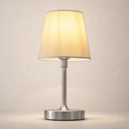Table lamp with beige shade and metallic base on a neutral background