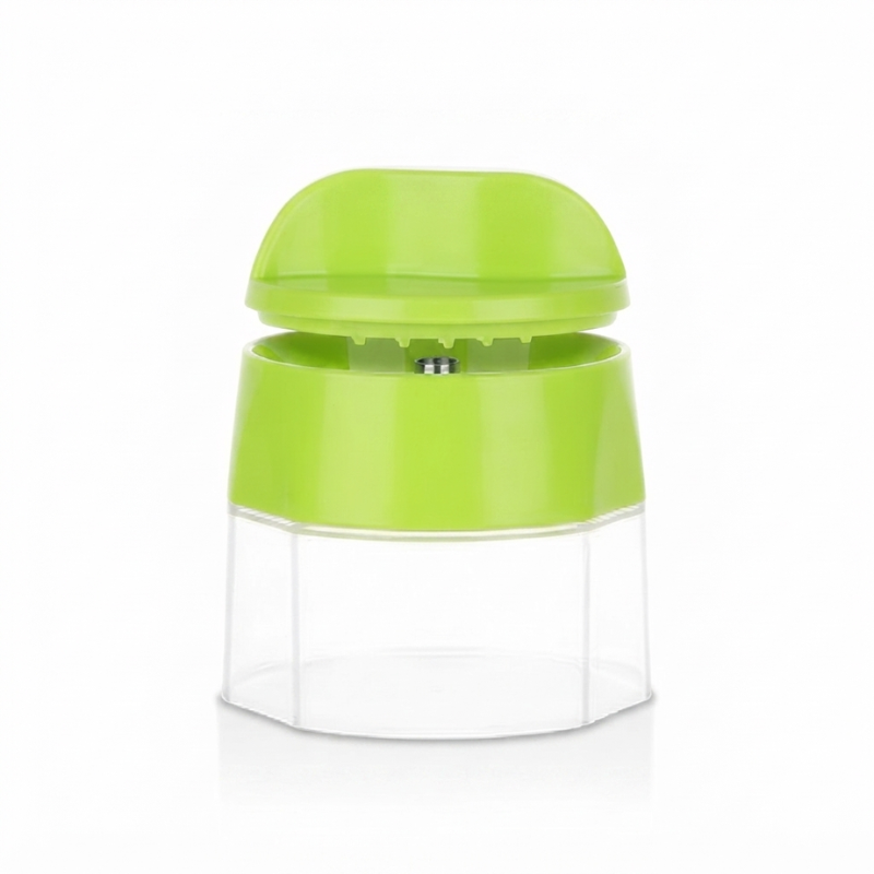 A bright lime green manual food chopper with a clear plastic container base, shown on a white background with a soft reflection.