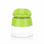 A bright lime green manual food chopper with a clear plastic container base, shown on a white background with a soft reflection.