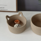Two woven baskets on a white surface with a blurred background