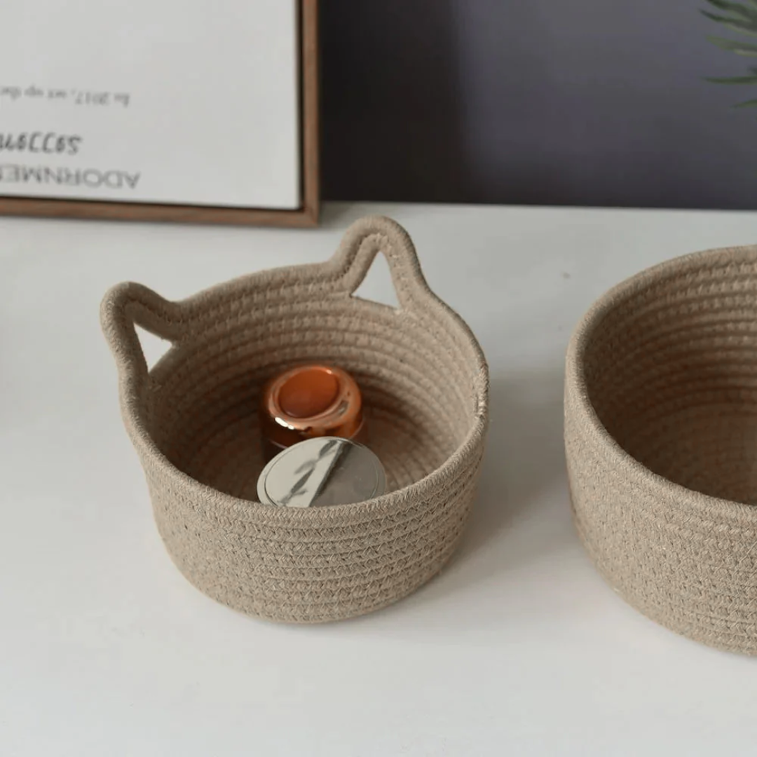 Two woven baskets on a white surface with a blurred background