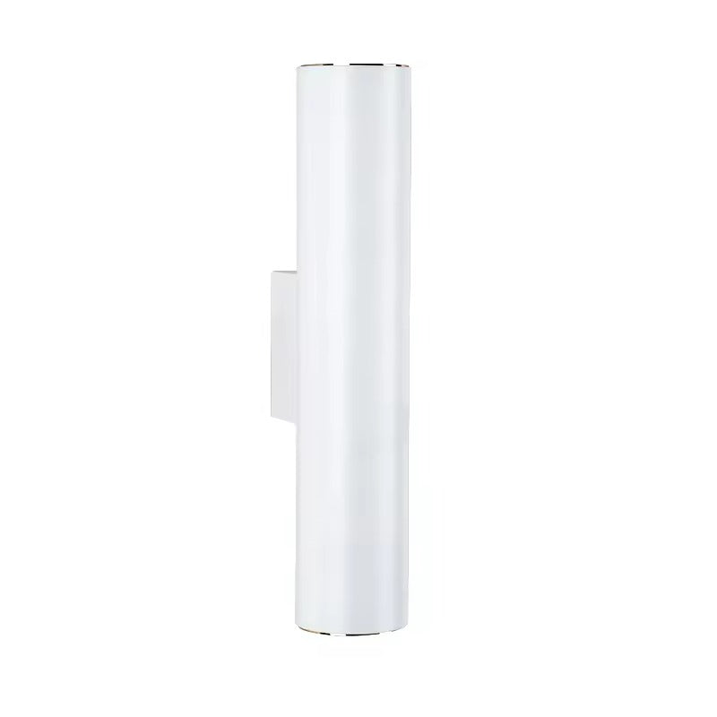 A modern cylindrical wall sconce light fixture in a matte white finish with polished silver metal trim at the top and bottom, shown against a plain white background.
