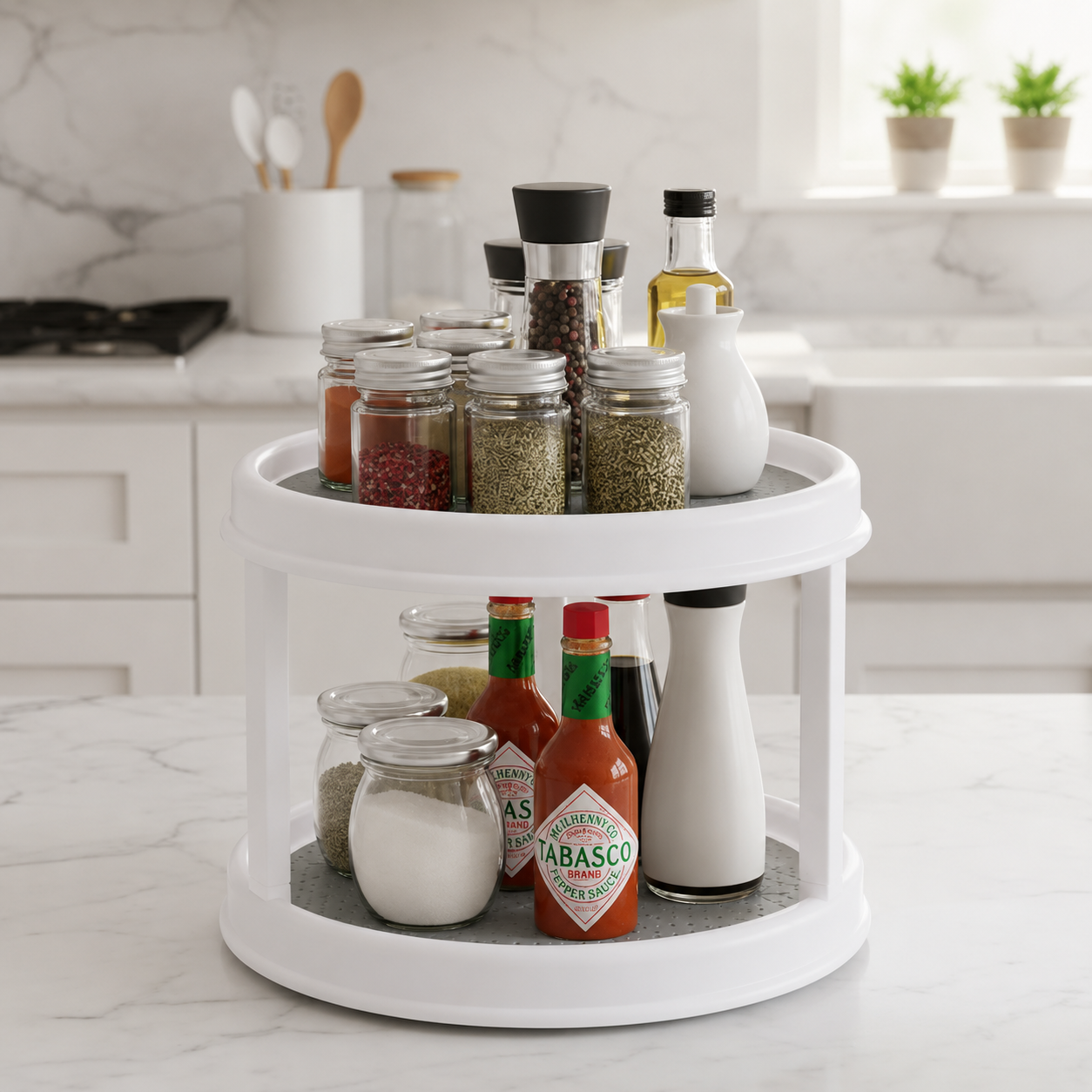 A white two-tier rotating spice rack filled with glass jars, bottles, and seasoning containers on a marble kitchen countertop, with a blurred kitchen background.