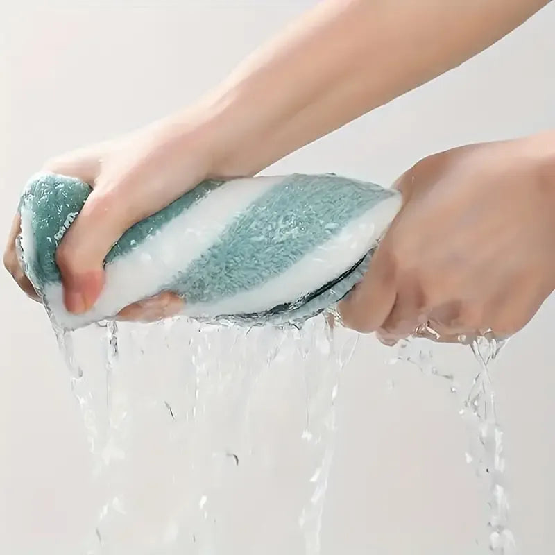 Hands holding a soapy sponge under running water on a light gray background