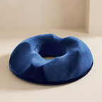 Blue donut pillow on a beige surface