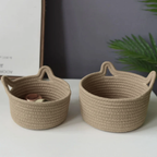 Two woven baskets on a white surface with a blurred background
