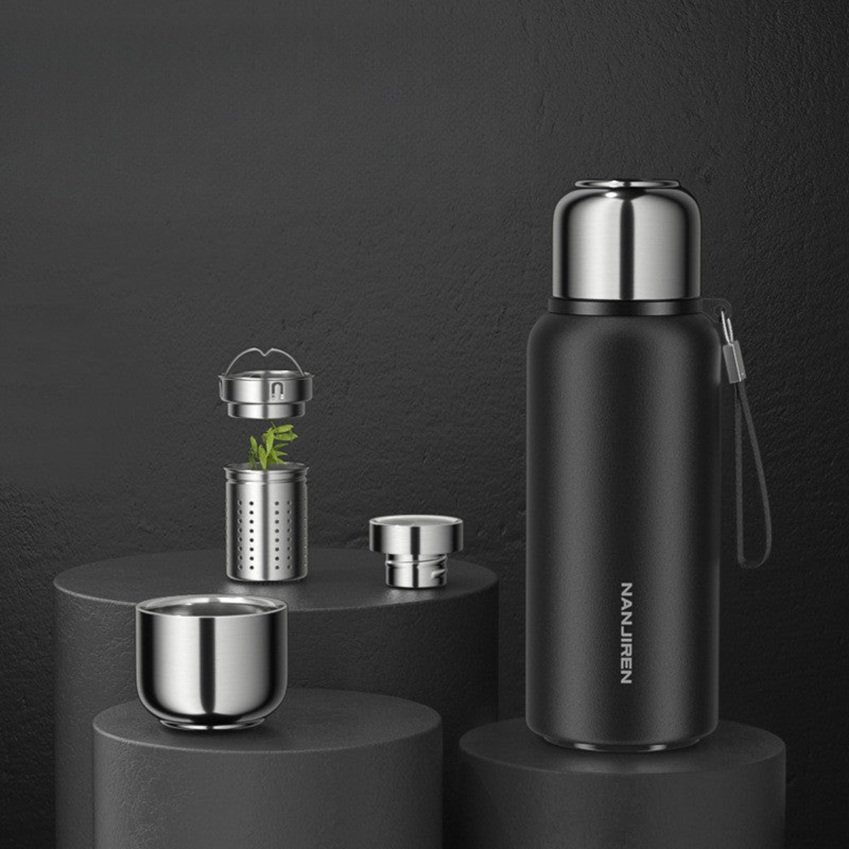 Black thermos bottle with components on a dark background