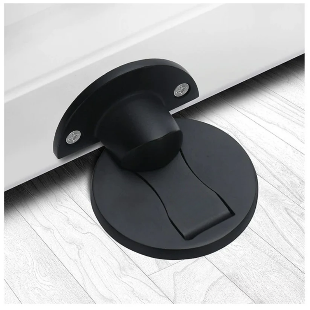 Black door stopper on a white floor
