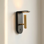 Modern wall light fixture with black and gold design on a neutral background