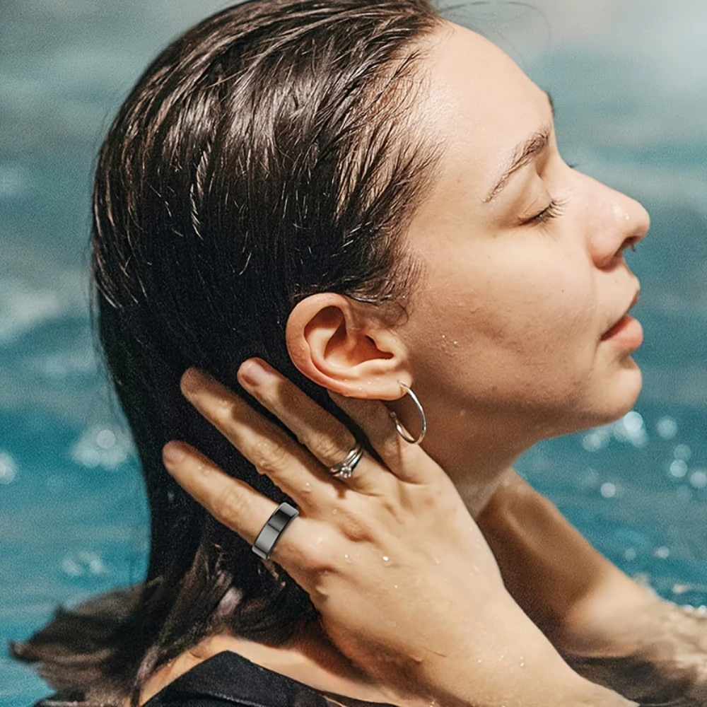 Woman with wet hair and hand near ear by water
