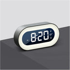 Digital clock with LED display on a gray surface