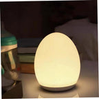 Egg-shaped night light on a surface with a blurred background