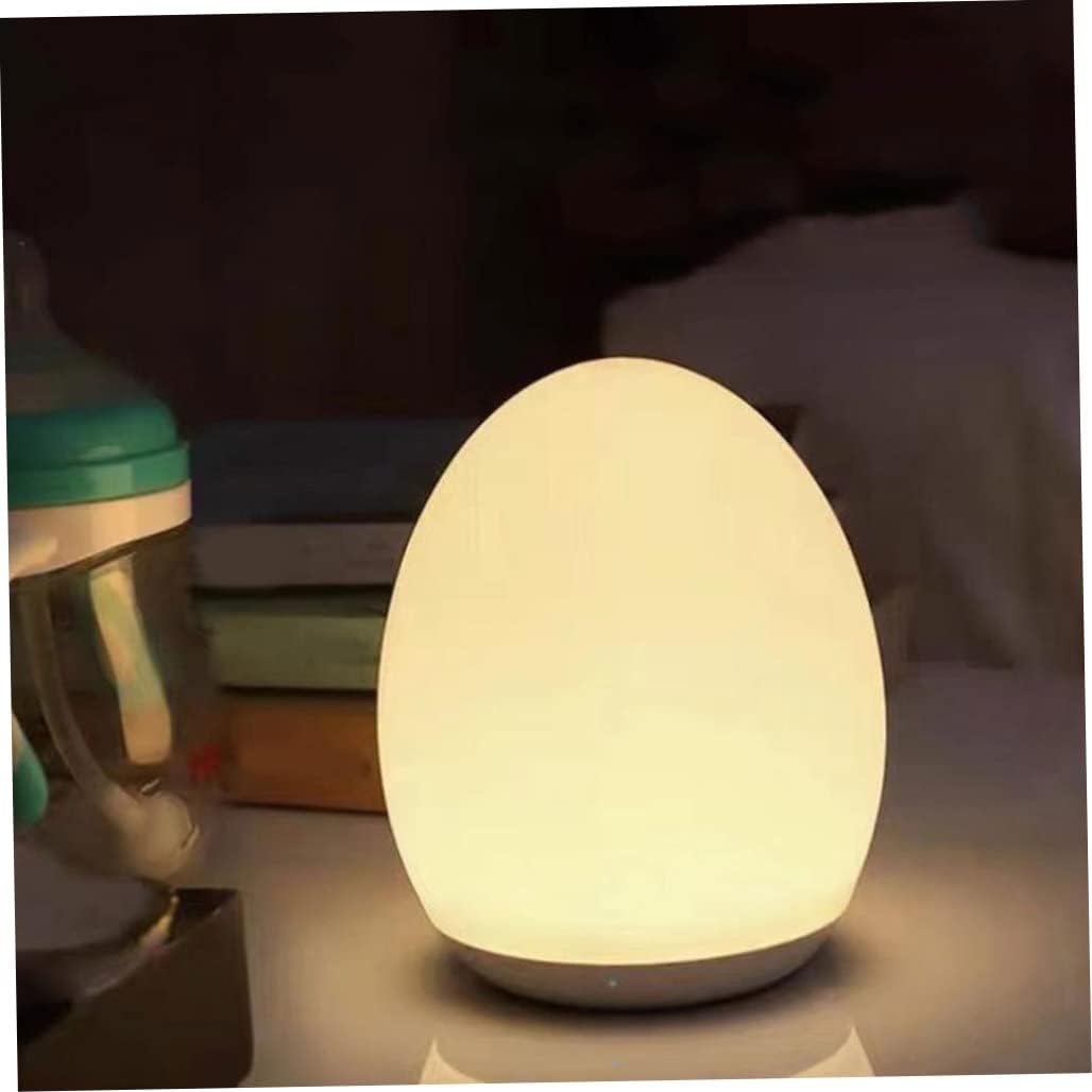 Egg-shaped night light on a surface with a blurred background