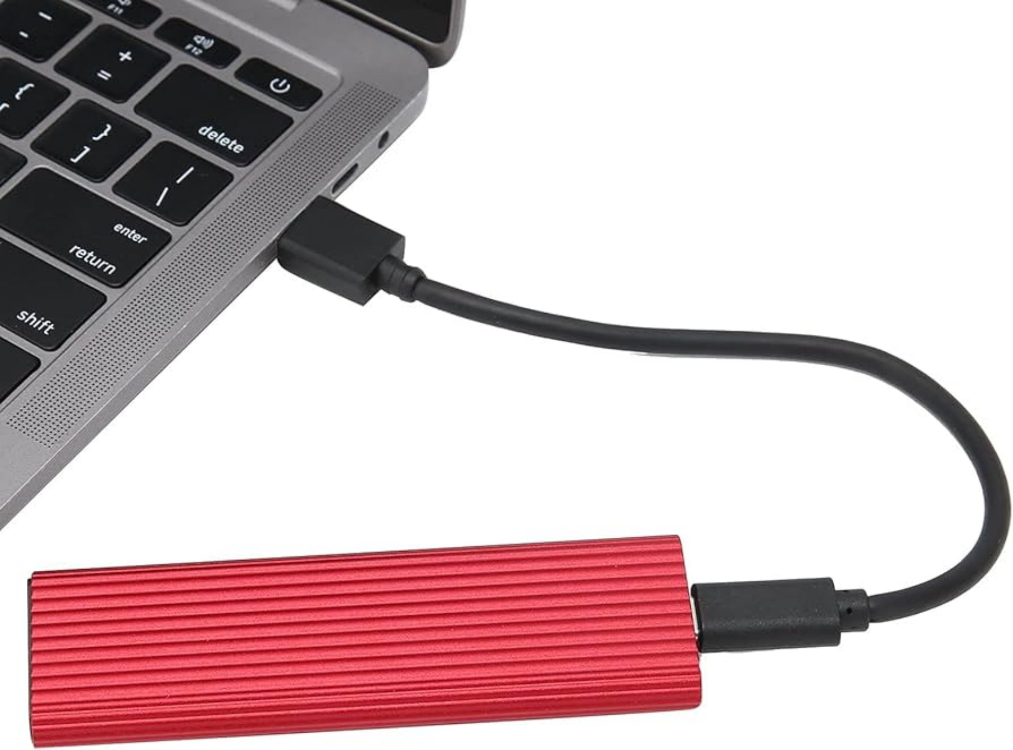 Red external hard drive connected to a laptop via USB cable on a white background
