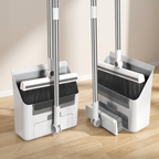 Two brooms with dustpan sets on a wooden floor.