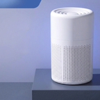 White cylindrical air purifier on a blue background