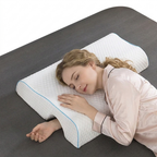 Woman sleeping on a gray bed with a white pillow