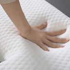 Hand resting on a textured white pillow