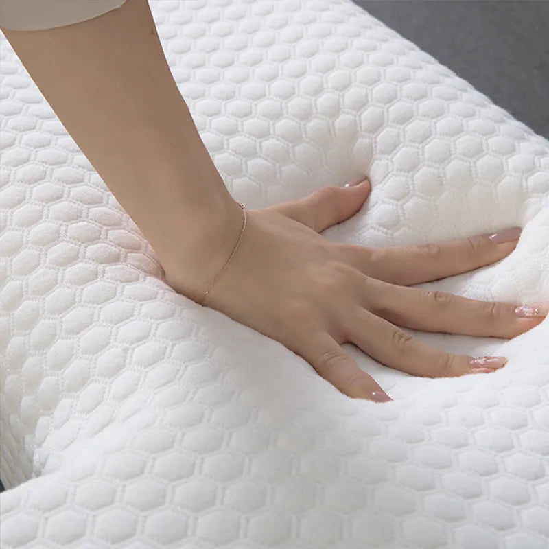 Hand resting on a textured white pillow