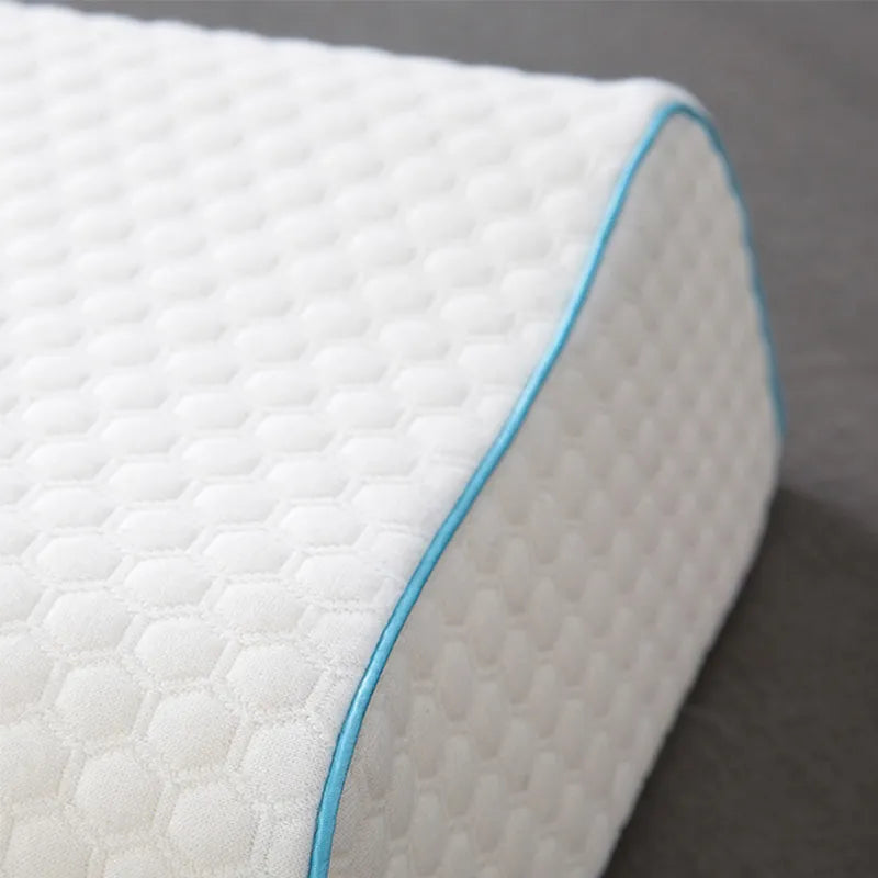 Close-up of a white mattress with a blue border on a gray background