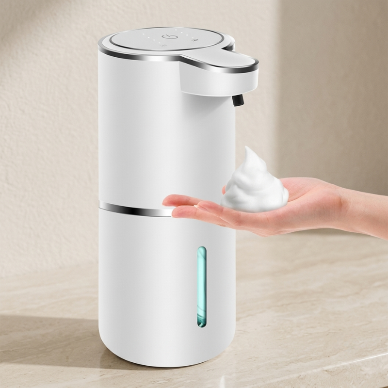 White soap dispenser dispensing soap onto a hand against a beige background