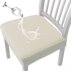 Cream-colored seat cover on a chair with a glass of water being poured onto it.