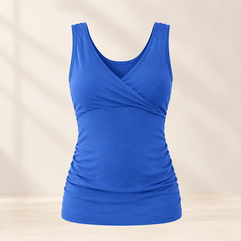A royal blue sleeveless tank top with a crossover V-neckline and ruched waist details, displayed on a light beige background with soft shadow overlays.