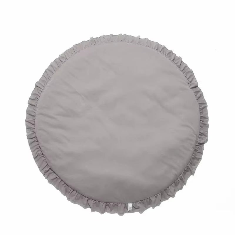 A round gray fabric cushion with a ruffled edge, shown from a top-down view on a plain white background.