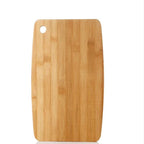 Wooden cutting board with a round hole on a white background