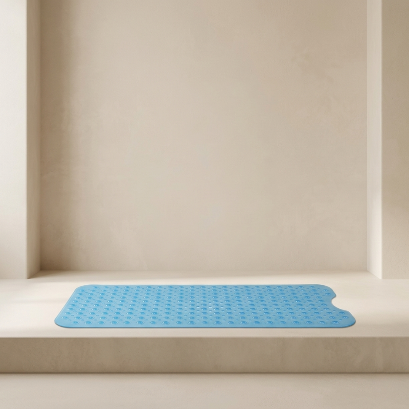 Blue bath mat on a beige bathtub ledge