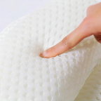 Hand touching a textured white mattress surface