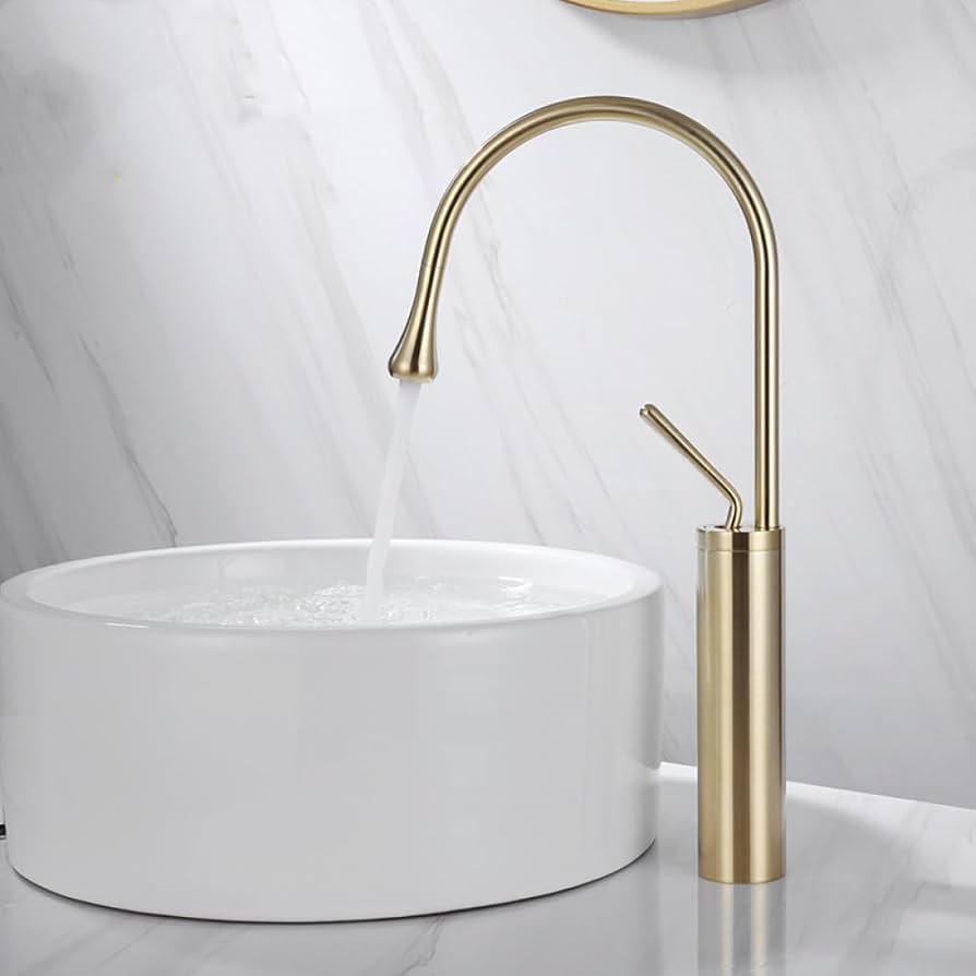 Gold faucet over a white sink against a light gray wall